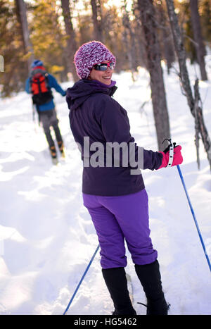 Young woman practicing Altai Skiing in Pyha ski resort, Lapland, Finland Stock Photo