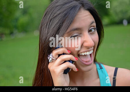Attractive young mixed race woman talking on mobile phone in Central Park, New York City Stock Photo