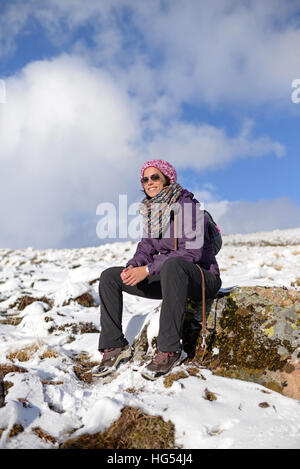 Portrait of young woman in snowy mountain Stock Photo