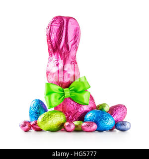 Chocolate easter eggs, rabbit with bow wrapped in pink foil and colorful candies isolated on white background clipping path included Stock Photo