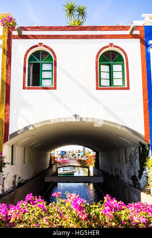 A unique building shaped like a bridge over a canal in Puerto De Mogan, a small fishing port in Gran Canaria. Stock Photo