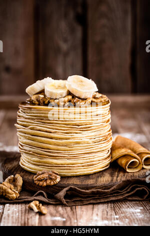 Plate of tasty pancakes with nuts and maple syrup on table Stock Photo ...