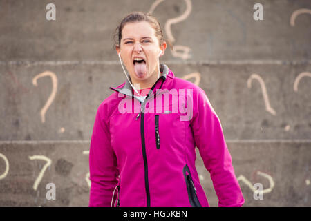 Theatre education in the UK: an Aberystwyth university theater studies undergraduate woman student performing a devised outdoor site-specific drama on location outside Aberystwyth Arts Centre, Wales UK Stock Photo