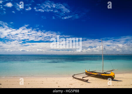 Small traditional pirogue on the shore of Nosy Ve island in Madagascar, Africa Stock Photo