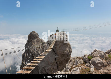 Man crossing the chasm Stock Photo