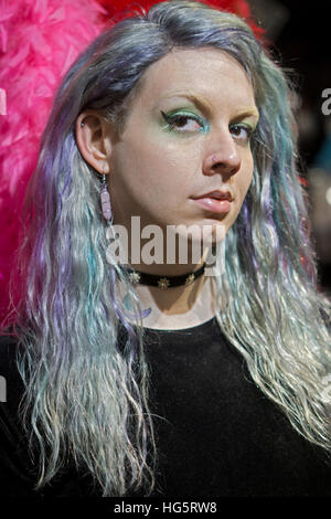 A transgender young lady with blue hair and sparkling eyeliner at a shop in Greenwich Village, Manhattan, New York City. Stock Photo