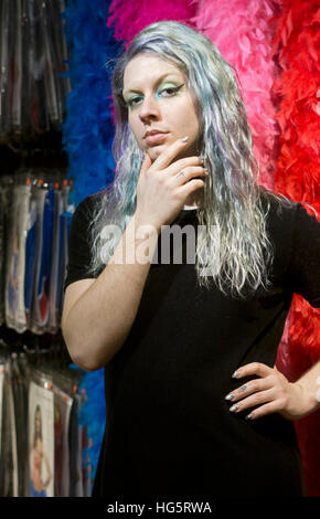A transgender young lady with blue hair and sparkling eyeliner at a shop in Greenwich Village, Manhattan, New York City. Stock Photo