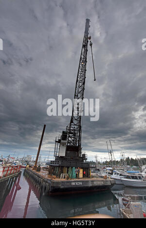 Pile driving crane on floating barge working in French creek harbour, Vancouver Island BC.Canada. SCO 11,356. Stock Photo