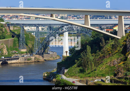 Ponte do Infante, Maria Pia Bridge and St John's Bridge over Douro river in Porto, Portugal. People are unrecognizable. Stock Photo