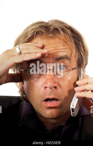 Man talking in mobile phone, cellphone, looking surprised Stock Photo