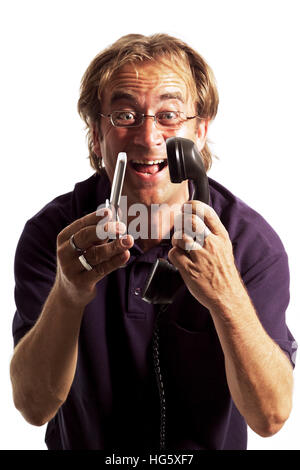 Man holding an old phone in one hand, mobile phone (cellphone) in the other Stock Photo