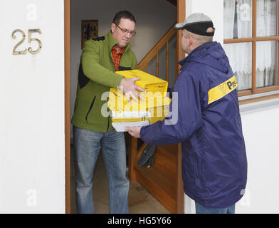 Postman delivering packages Stock Photo
