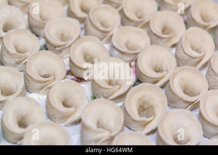 Homemade uncooked uszka traditional ukrainian dumplings filled with mushrooms for Christmas Stock Photo