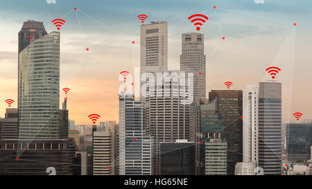 Concept of IOT and smart city illustrated by wireless networking and Wifi icon. Stock Photo