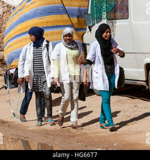 Elkhorbat, Morocco.  Young Afro-Berber Women Walking in the Market. Stock Photo