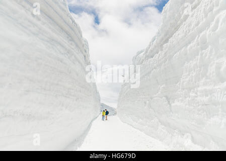 Tateyama, Japan - May 2, 2014: Unidentified tourists  visit at snow wall on Tateyama Kurobe Alpine Route,  Japanese Alps in Tateyama, Japan Stock Photo