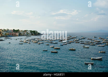 Small fishing boats moored in the harbour off the coast of the island of Ischia, in the bay of Naples. Stock Photo