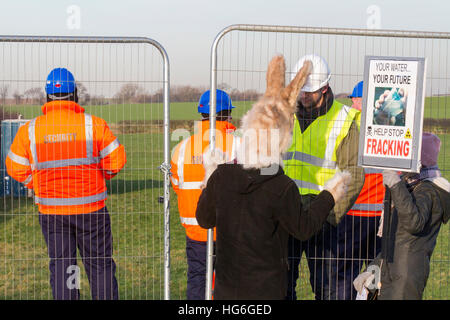 Little Plumpton, Lancashire, UK. 5th Jan 2017. 'Hop It'  Help stop fracking demonstrators protest as Security moves into the heavily protected area of Little Plumpton, a site designated for the installation of four wells for shale gas extraction by the notorious 'Fracking' process. Protesters claim this fracturing process is linked to water pollution, ill health and earthquakes. This controversial Cuadrilla 'Fracking' site was approved on appeal by Communities Secretary Sajid Javid in early December 2016, overturning Lancashire County Councils previous refusal. © Cernan Elias/Alamy Live News Stock Photo