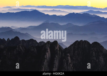 Huangshan, Huangshan, China. 5th Jan, 2017. Huangshan, CHINA-January 5 2017: (EDITORIAL USE ONLY. CHINA OUT).Sunrise at Mount Huangshan in Huangshan City, east China's Anhui Province, January 5th, 2017. Mount Huangshan, also known as Yellow Mountain, is well known for its scenery, peculiarly-shaped granite peaks, Huangshan pine trees, hot springs, winter snow, and views of the clouds from above. Huangshan is a frequent subject of traditional Chinese paintings and literature, as well as modern photography. It is a UNESCO World Heritage Site, and one of China's major tourist destinations. (C Stock Photo