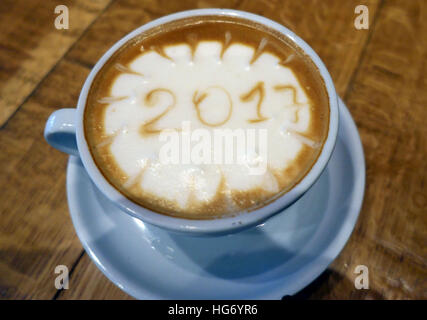 Year 2017 drawn in froth of cup of coffee, London Stock Photo