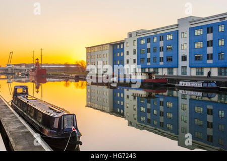 The sun setting behind Gloucester College, beside the Gloucester Sharpness Canal, Gloucester Docks UK Stock Photo