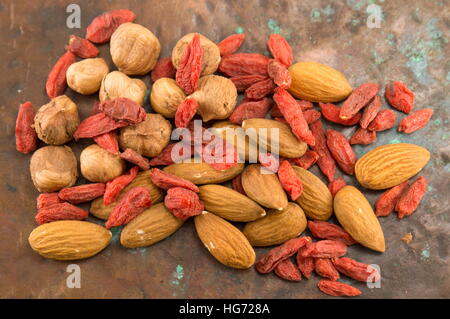 goji berries almonds and nuts on vintage background Stock Photo