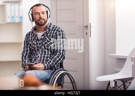 Attractive disabled man dreaming about something Stock Photo