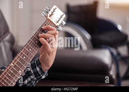 Talented disabled man playing guitar Stock Photo