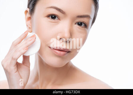 Pretty cheerful woman cleaning her face Stock Photo