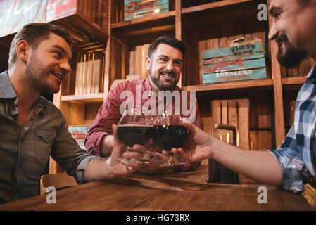 Positive delighted friends enjoying their evening Stock Photo