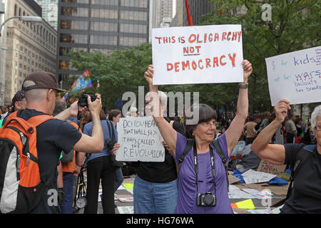 Occupy Wall Street protester camp at Zuccotti Park woman holds a placard Stock Photo