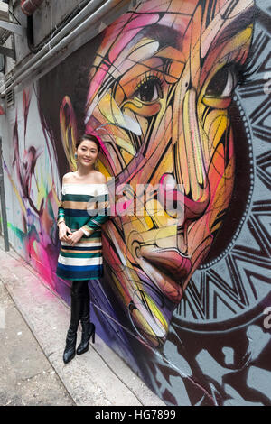 Wall painting by Parisian street artist Alexandre Monteiro aka Hopare of Hong Kong actress and canto pop star Niki Chow (pictured) 'Walls of Change' s Stock Photo