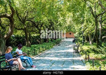 New York City,NY NYC Manhattan,Spanish Harlem,Central Park,urban,tree lined path,bench,Black adult adults,woman female women,sitting,NY160723046 Stock Photo