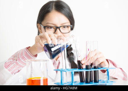 Young female researcher carrying out scientific research in a lab. Stock Photo