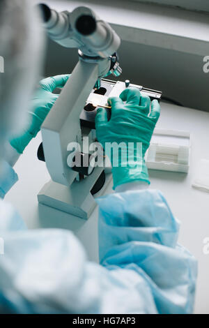 Crop hands putting microscope glasses in box Stock Photo