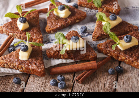 Sweet cinnamon toast with butter and blueberries close-up on the table. Horizontal Stock Photo