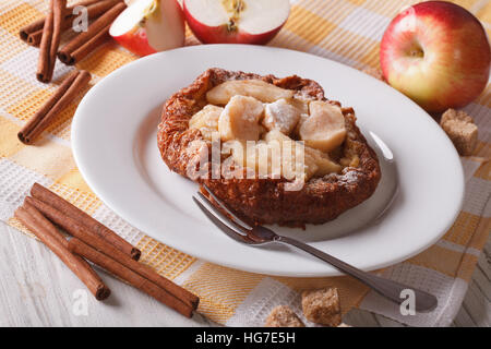 Delicious Dutch baby pancakes with apples on a plate on the table. horizontal Stock Photo