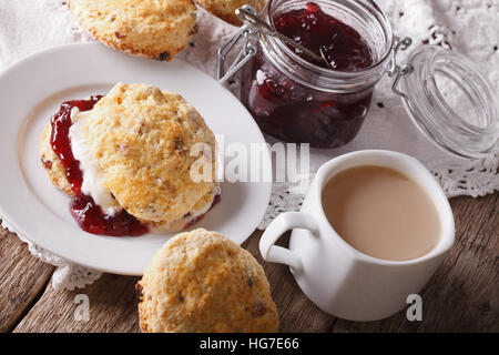 Homemade scones with jam and tea with milk close-up on the table. horizontal Stock Photo