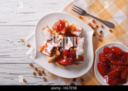 Delicious omelette Kaiserschmarrn with plum sauce on a plate. horizontal top view Stock Photo