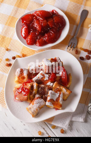 Sweet Kaiserschmarrn and plum sauce close-up on a plate. vertical Stock Photo