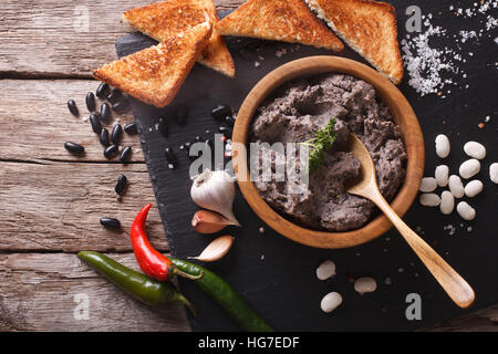 Frijoles refritos with ingredients on a table close-up. horizontal view from above Stock Photo