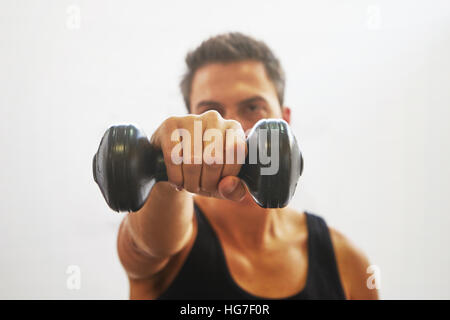 Fit muscular man exercising with dumbbell Stock Photo