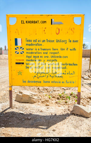 Ksar Elkhorbat, Morocco.  Multilingual Sign Requesting Visitors to Conserve Water. Stock Photo