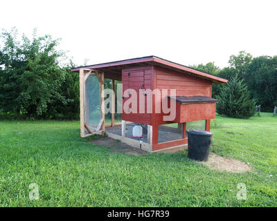red chicken coop made of wood and metal screen Stock Photo