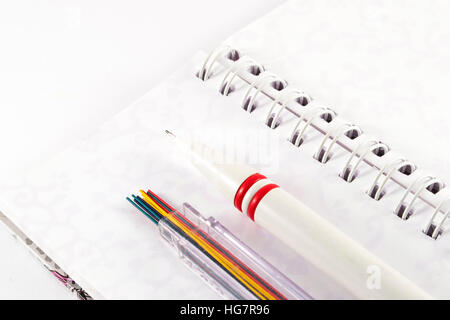 Mechanical pencil with pencil leads on white notebook Stock Photo