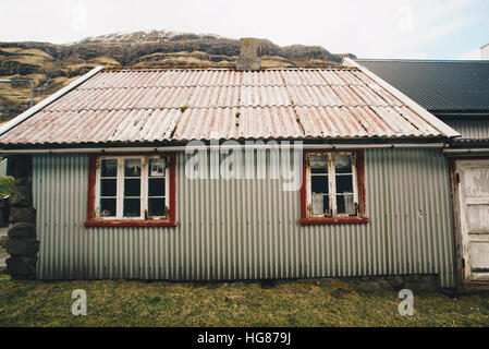 Corrugated iron house on field Stock Photo