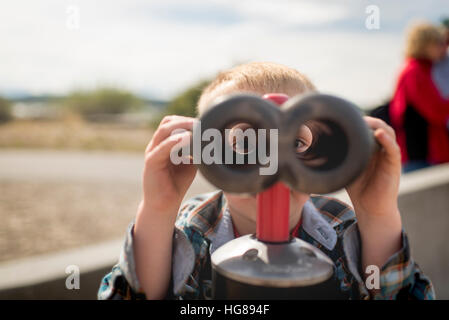 Portrait of boy looking through binoculars Stock Photo