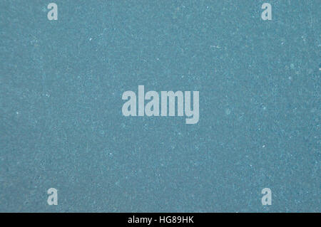 Early morning frost on a windshield gives an even, grainy greeny blue background with some white flecks. Stock Photo