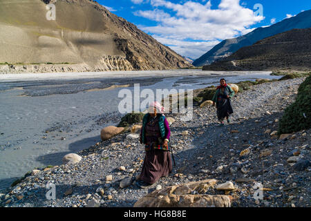 Two local women walking at river, near Jomsom, Kali Gandaki valley, Mustang District, Nepal Stock Photo