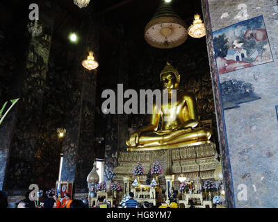 The main Buddha statue inside the prayer hall of Wat Suthat Thep Wararam. Stock Photo